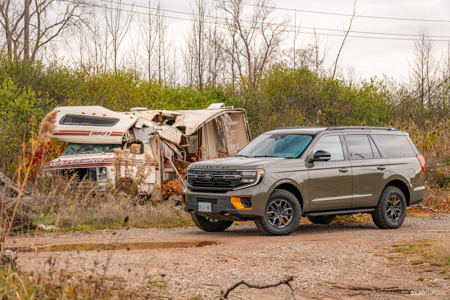 2025 Ford Expedition Tremor in Wild Green positioned menacingly next to a destroyed Winnebago
